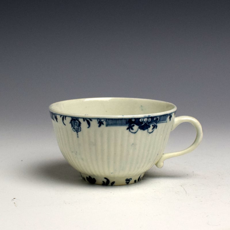 Early Worcester Rib Moulded Tea Cup and Saucer with Lambrequin Border c1760 (2)